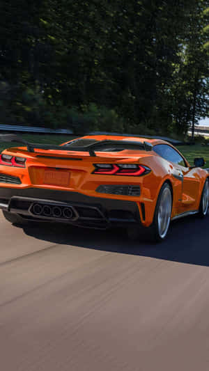 Orange Corvette C8 Rear View Speeding Wallpaper