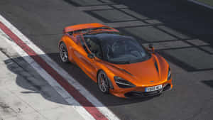 Orange Coupe On Racetrack Wallpaper