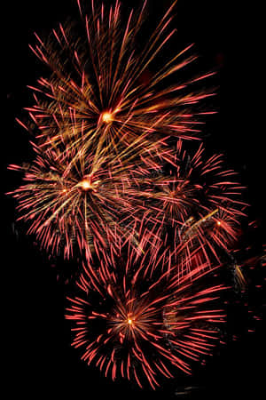 Orange Fireworks Display In Dark Sky Wallpaper