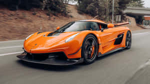 Orange Koenigsegg Jesko Speeding Wallpaper