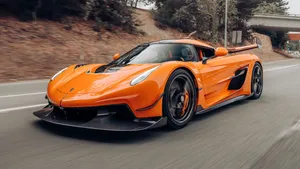 Orange Koenigsegg Jesko Speeding Wallpaper