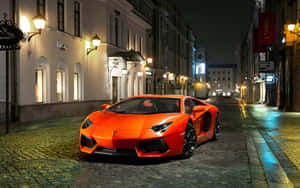 Orange Sports Coupe Nighttime City Wallpaper