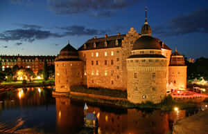 Orebro Castle Night Reflection Sweden Wallpaper