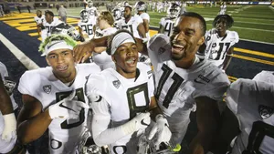 Oregon Ducks Football Players Celebrating Victory Wallpaper