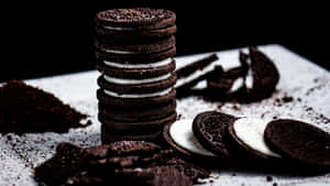 Oreo Cookies On A White Plate With A Pile Of Crumbs Wallpaper