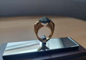 Ornate Golden Ringwith Black Stone Wallpaper