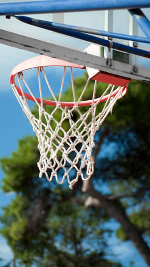 Outdoor Basketball Hoop Against Blue Sky Wallpaper