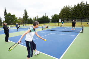 Outdoor Pickleball Gamein Action.jpg Wallpaper