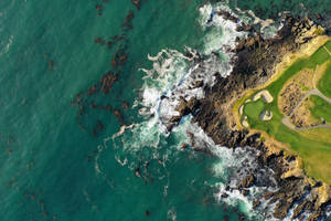 Overhead Shot Of Golf Course Near Rocky Shore Wallpaper