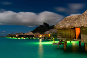 Overwater Bungalows At Sunset In Bora Bora Beach Wallpaper