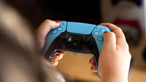 P S5 Controller In Hands Wallpaper