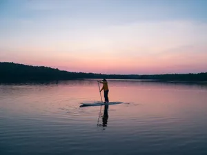 Paddleboarder Enjoying The Sunset Wallpaper