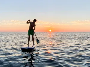 Paddleboarding At Sunset Wallpaper