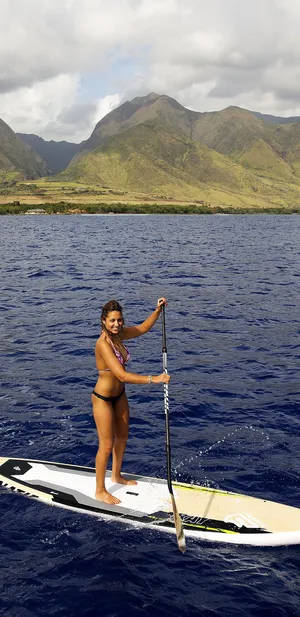 Paddleboarding At Sunset On Tranquil Waters Wallpaper