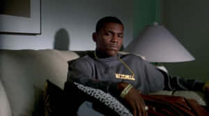 Paid In Full Movie Scene Character On Couch Wallpaper