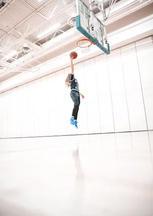 Paige Bueckers Basketball Dunk Wallpaper