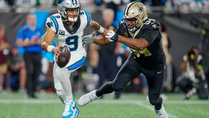 Panthers Quarterback Evades Saints Defender Wallpaper