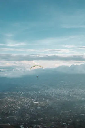 Paragliding Above Banos City Wallpaper