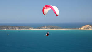 Paragliding Above Lagoon Wallpaper