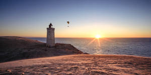 Paragliding Near Lighthouse Wallpaper