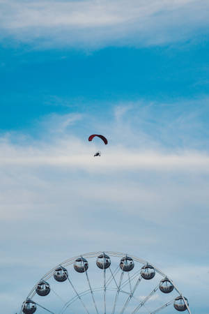 Paragliding Over Ferris Wheel Wallpaper