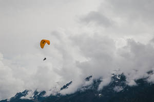 Paragliding Over Swiss Alps Wallpaper