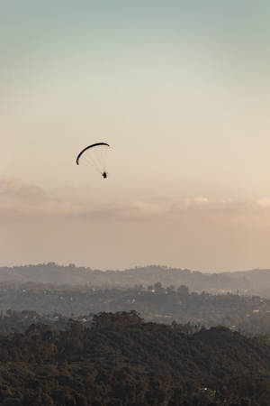 Paragliding Under Pastel Sky Wallpaper