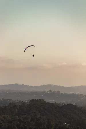 Paragliding Under Pastel Sky Wallpaper