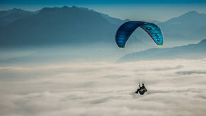 Parasailing Above The Clouds Wallpaper