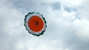 Parasailing Adventure Against Blue Skies Wallpaper