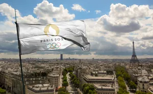Paris2024 Olympics Flag Eiffel Tower View Wallpaper