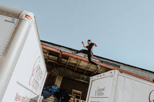 Parkour Above Trucks Wallpaper