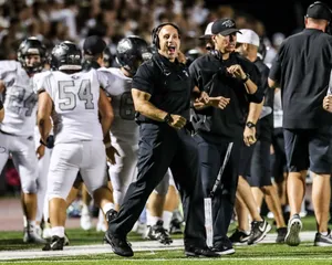 Passionate Football Coach Strategizing On The Field Wallpaper