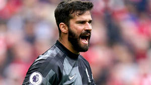 Passionate Goalkeeper Alisson Becker Expresses Intensity On The Field Wallpaper