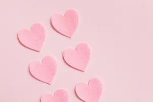 Pastel Pink Heart Cutouts In Pairs Wallpaper