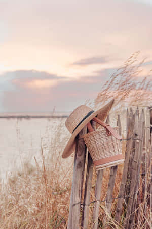 Pastel Summer Sunsetwith Straw Hatand Bag Wallpaper