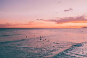 Pastel Sunset Surfers Beach Aesthetic.jpg Wallpaper