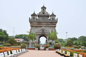 Patuxai Monument With Chairs In Front Wallpaper