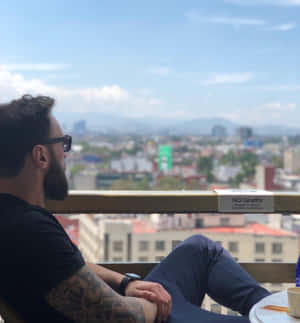 Paul Craig Relaxing On Balcony Wallpaper