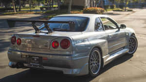 Paul Walker Tearing Up The Asphalt In A Nissan Skyline Wallpaper