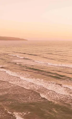 Peach Hued Beach Sunset Wallpaper