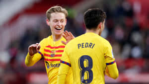 Pedri Celebratingwith Teammate Football Match Wallpaper