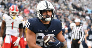 Penn State Football Player Running With The Ball Wallpaper