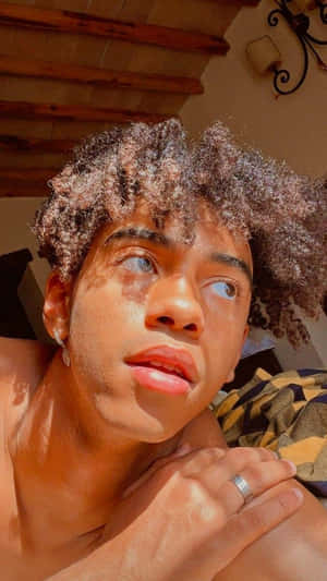 Pensive Young Manin Sunlight Wallpaper