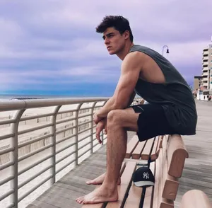 Pensive Young Manon Boardwalk Wallpaper