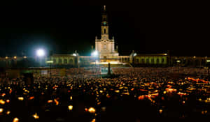 People Holding Lights Outside Fatima Sanctuary Wallpaper