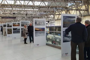 People Looking At Waterloo Station Exhibit Wallpaper