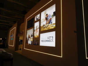 People Viewing Artwork At The International Art Exhibition Wallpaper