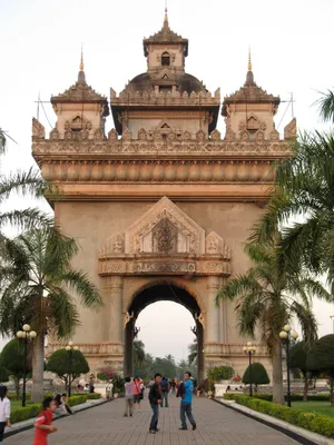 People Walking Through Patuxai Monument Wallpaper