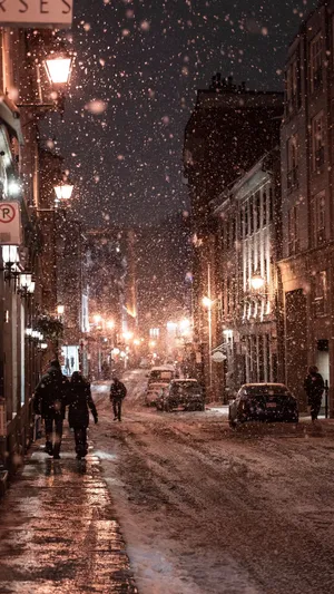 People Walking With Snow Falling Wallpaper